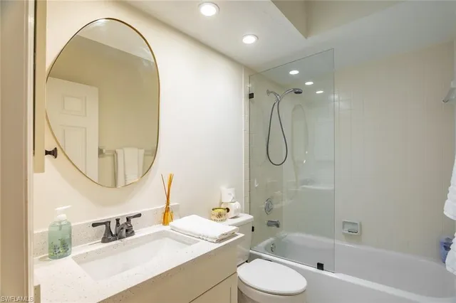 a bathroom with a toilet sink and a mirror
