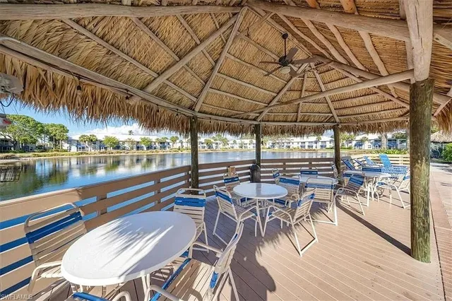 a view of a swimming pool with outdoor seating and plants