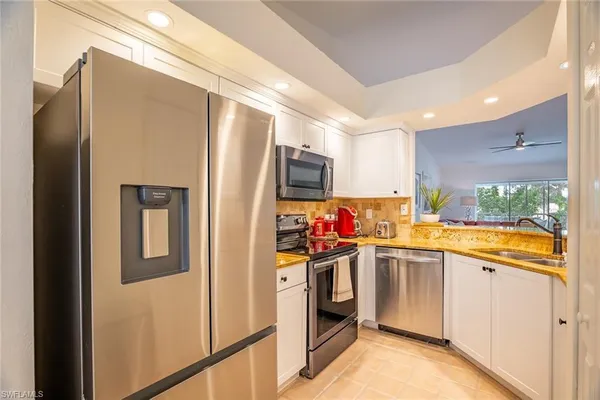a kitchen that has a refrigerator and a sink
