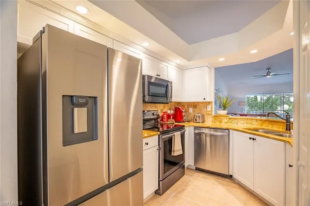 a kitchen that has a refrigerator and a sink