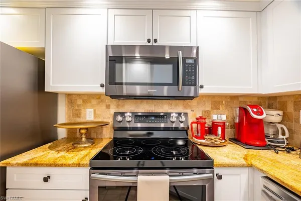 a stove top oven sitting inside of a kitchen