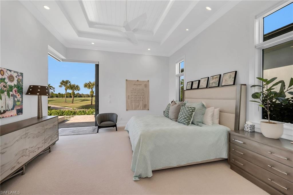 1671 Vinland Way Naples, FL 34105 - Photo 14 of 50 a bedroom with a bed and a couch