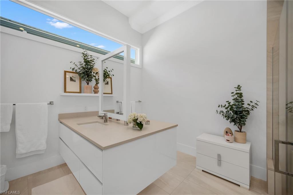 1671 Vinland Way Naples, FL 34105 - Photo 17 of 50 a bathroom with a sink a toilet and shower