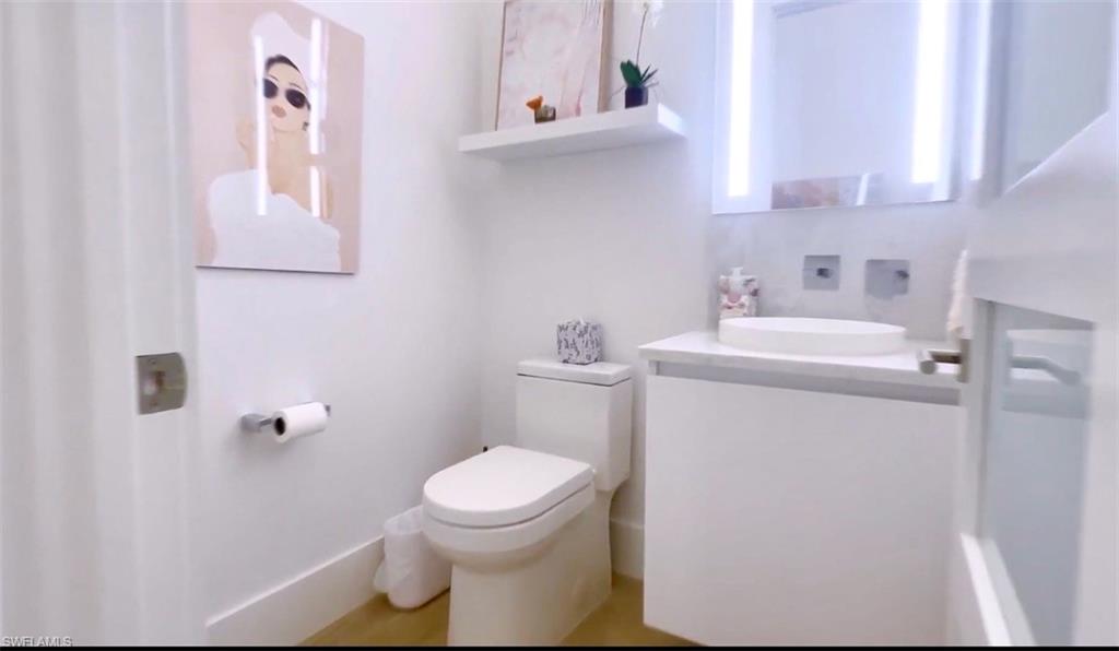 1671 Vinland Way Naples, FL 34105 - Photo 23 of 50 a bathroom with a sink toilet and vanity