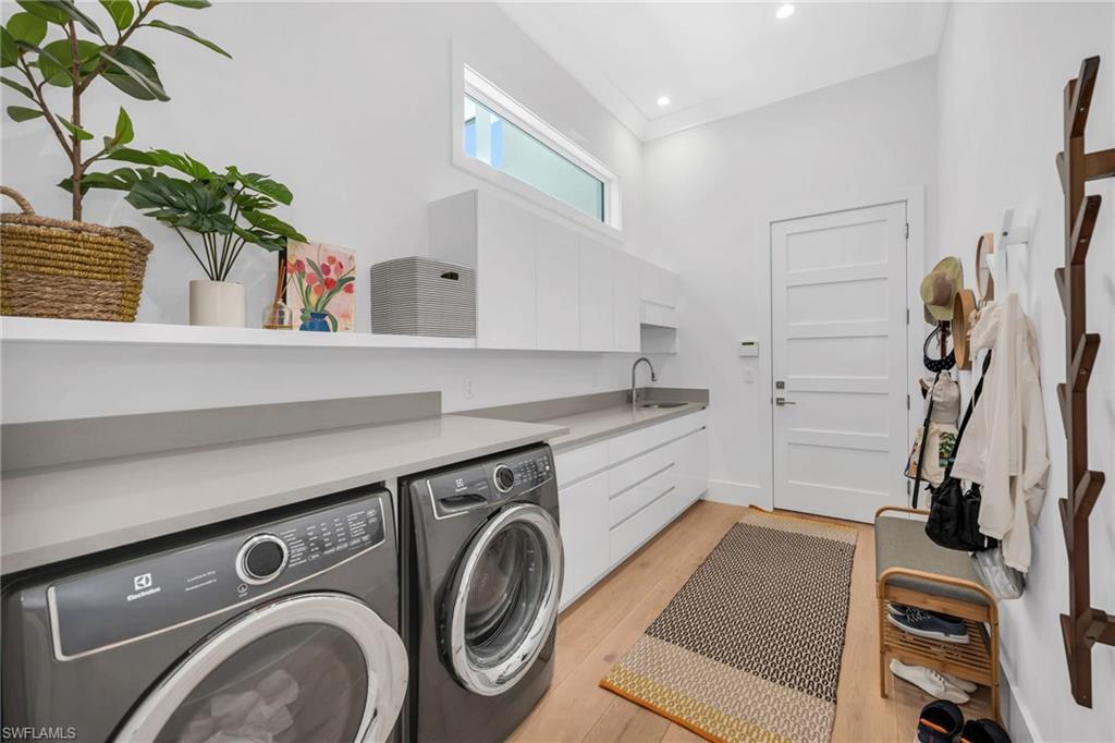 1671 Vinland Way Naples, FL 34105 - Photo 24 of 50 a utility room with sink dryer and washer