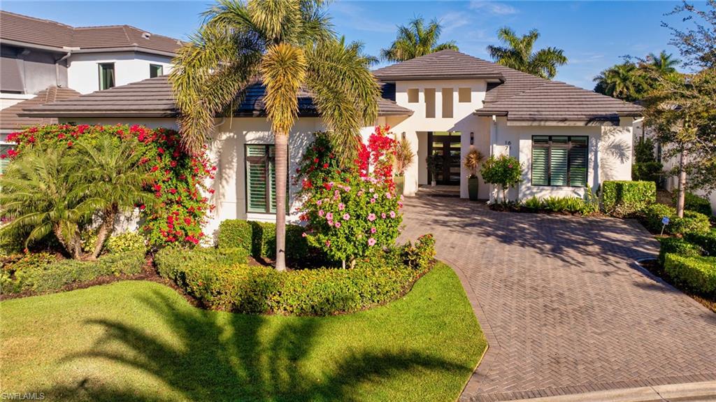 1671 Vinland Way Naples, FL 34105 - Photo 33 of 50 a front view of a house with garden