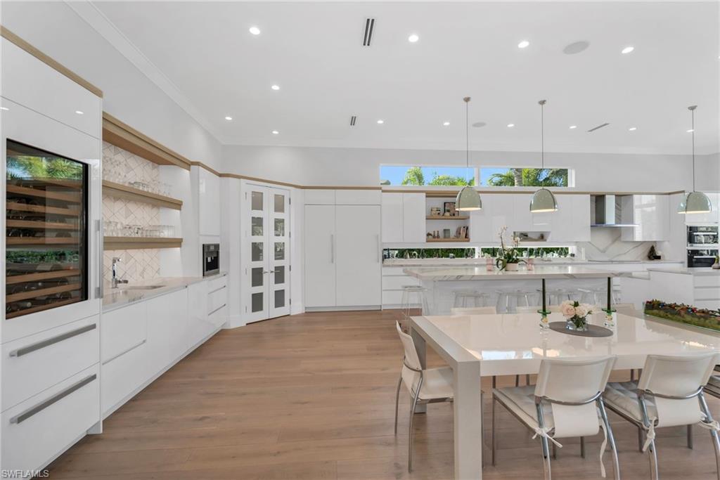1671 Vinland Way Naples, FL 34105 - Photo 6 of 50 a kitchen with stainless steel appliances kitchen island granite countertop a stove a sink and a refrigerator