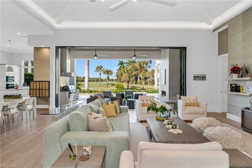 1671 Vinland Way Naples, FL 34105 - Photo 9 of 50 a living room with furniture and a large window