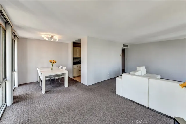 a living room with a white furniture and a table