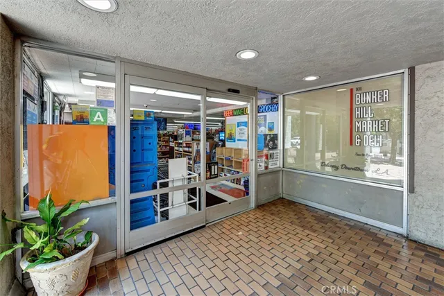 a room with lots of wooden furniture and potted plant