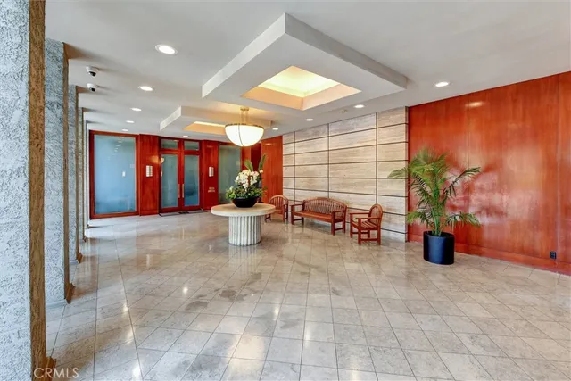 a living room with furniture and potted plants