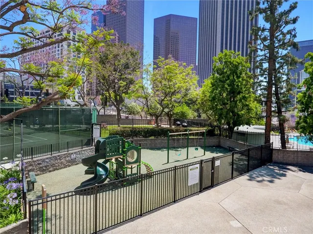 a view of small space with a car parked in the background