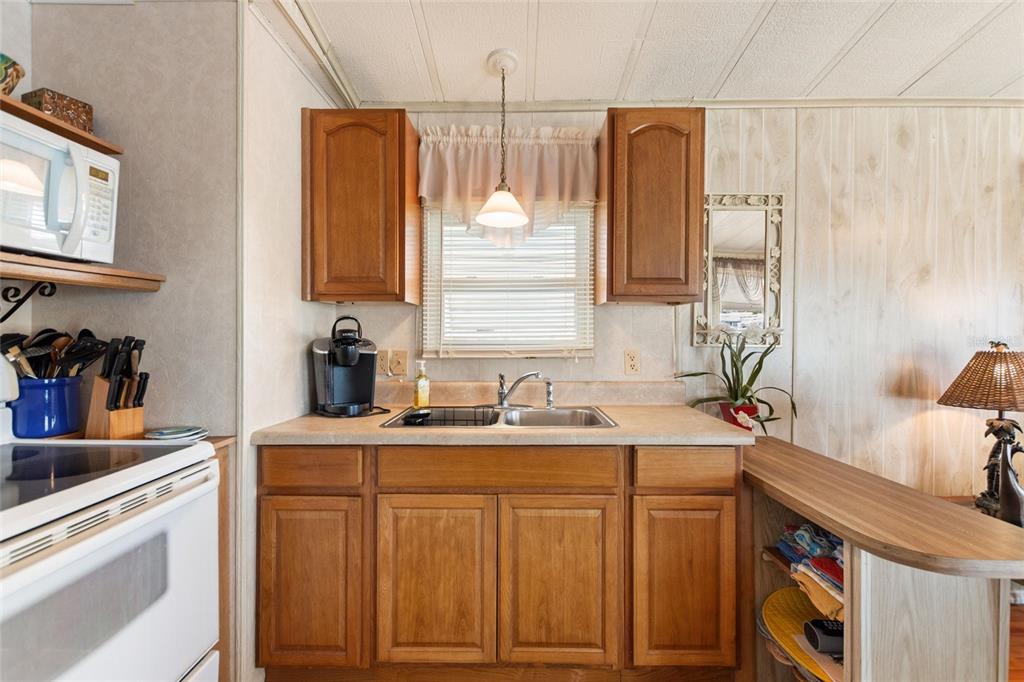 251 Patterson Road, Unit G9 Haines City, FL 33844 - Photo 14 of 40 a kitchen with a sink cabinets and window