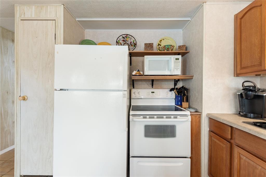 251 Patterson Road, Unit G9 Haines City, FL 33844 - Photo 15 of 40 a white refrigerator freezer sitting inside of a kitchen