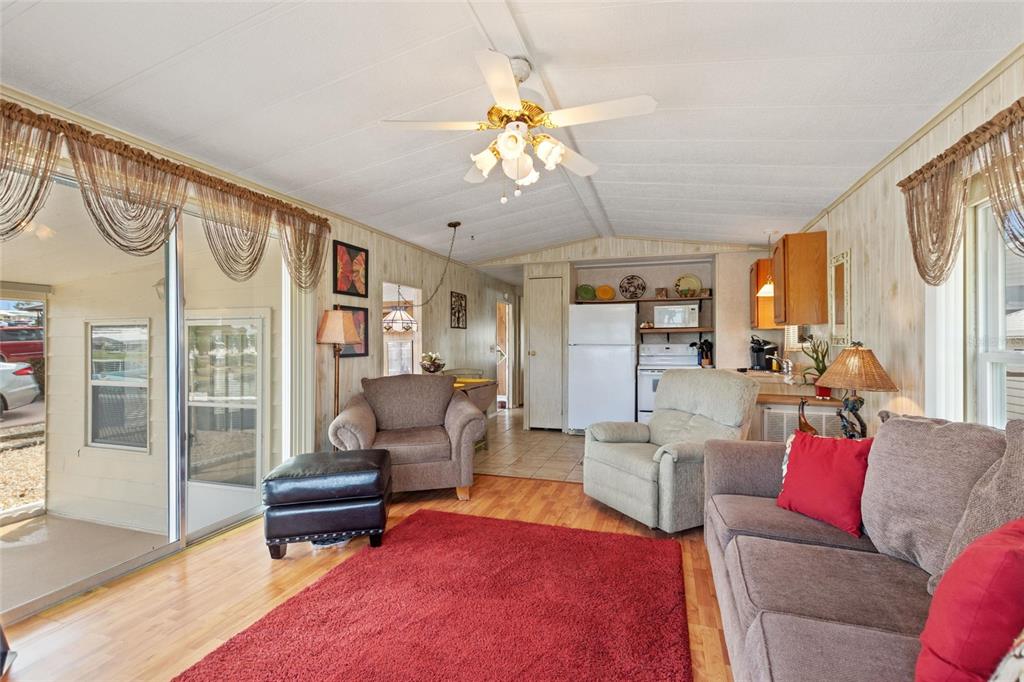 251 Patterson Road, Unit G9 Haines City, FL 33844 - Photo 19 of 40 a living room with furniture a dining table and a piano table
