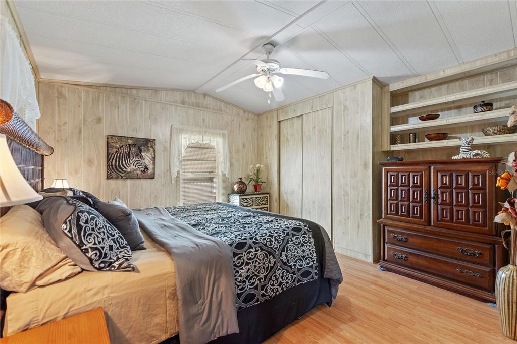 251 Patterson Road, Unit G9 Haines City, FL 33844 - Photo 21 of 40 a bedroom with a large bed and a chandelier