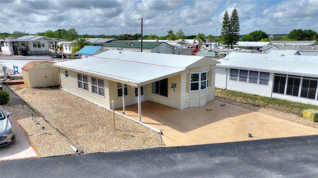 251 Patterson Road, Unit G9 Haines City, FL 33844 - Photo 27 of 40 an aerial view of a house with a garden and parking