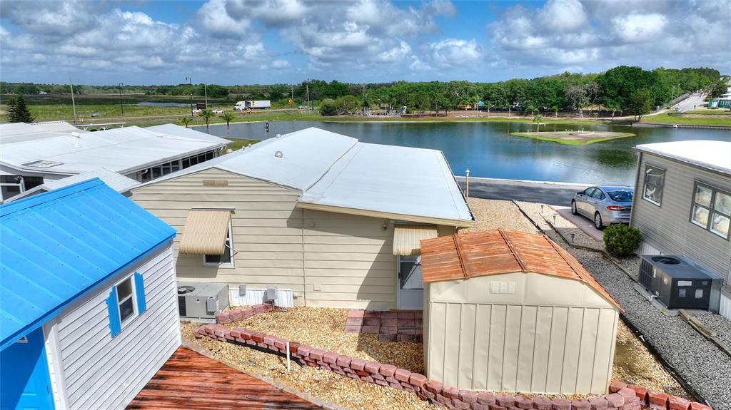 251 Patterson Road, Unit G9 Haines City, FL 33844 - Photo 29 of 40 a view of a lake with a house in the background