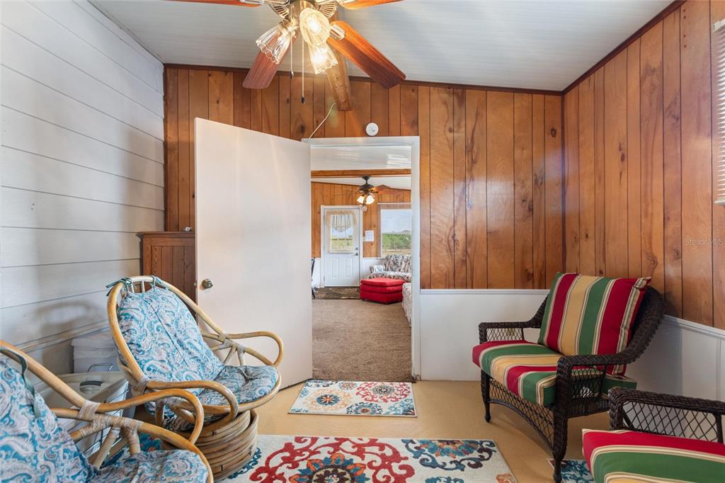 251 Patterson Road, Unit G9 Haines City, FL 33844 - Photo 10 of 40 a bedroom with furniture and a chandelier