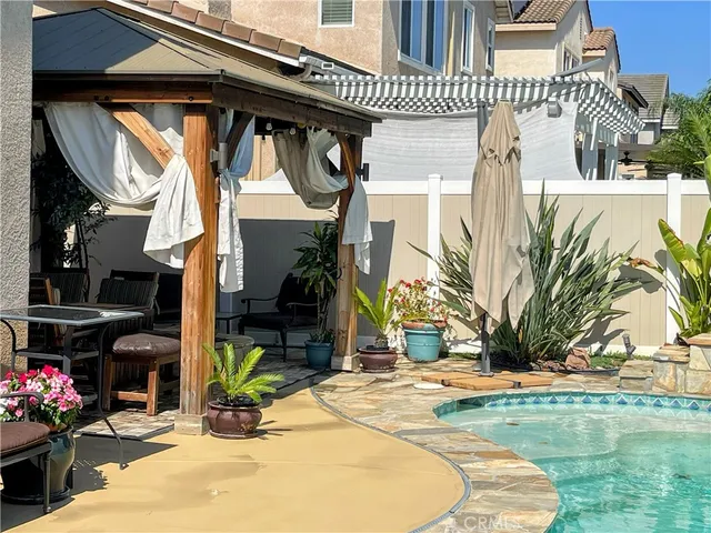 a view of a backyard with plants and outdoor seating