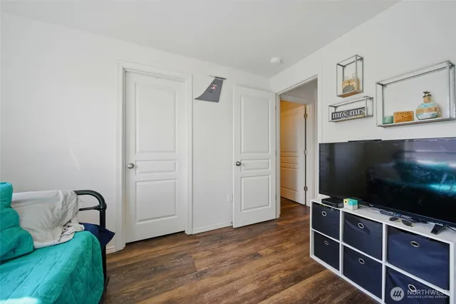 a bedroom with a bed and a wall painting