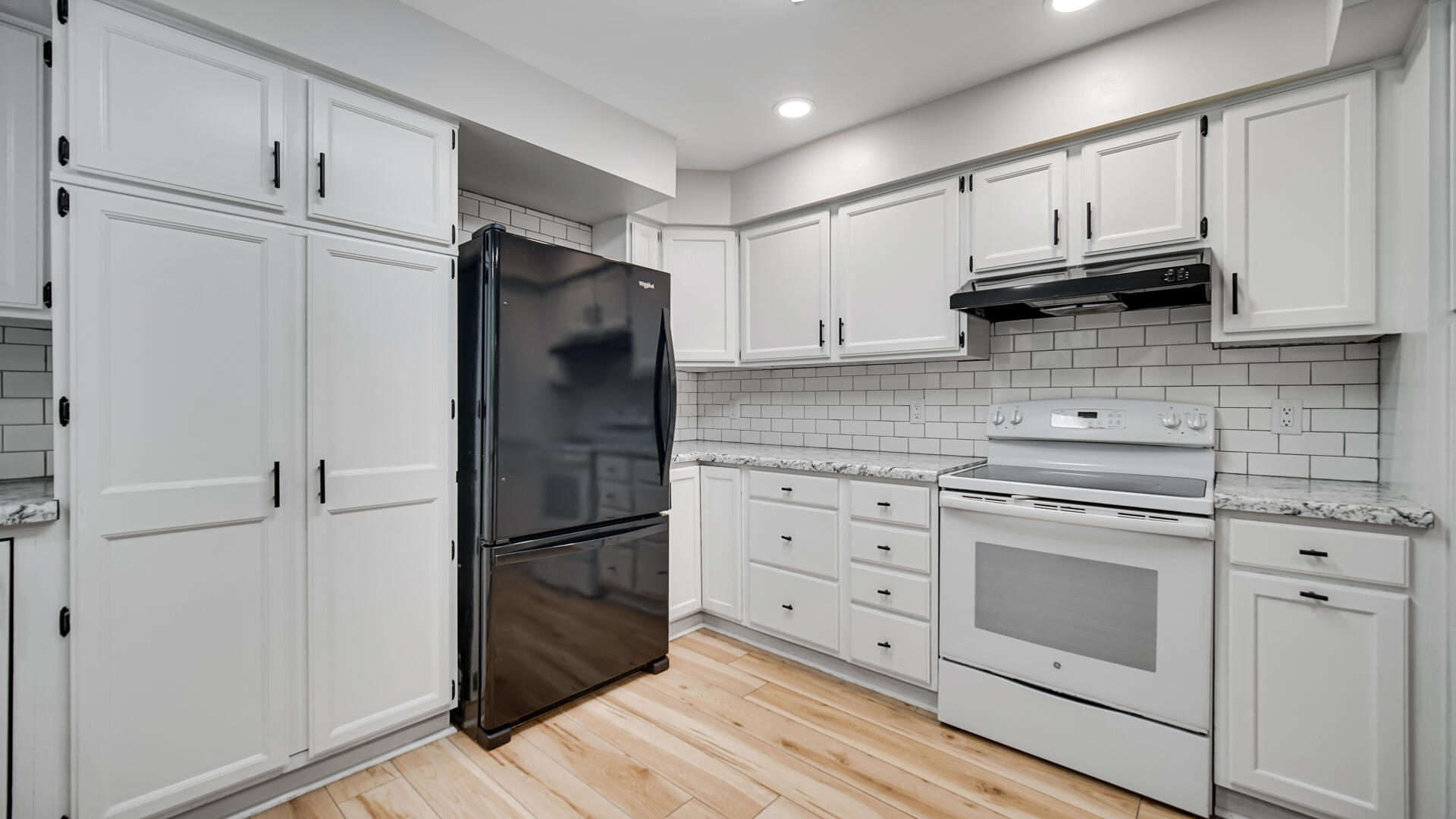 6717 State Rte 49 Rensselaer, IN 47978 - Photo 12 of 31 a kitchen with granite countertop white cabinets and stainless steel appliances