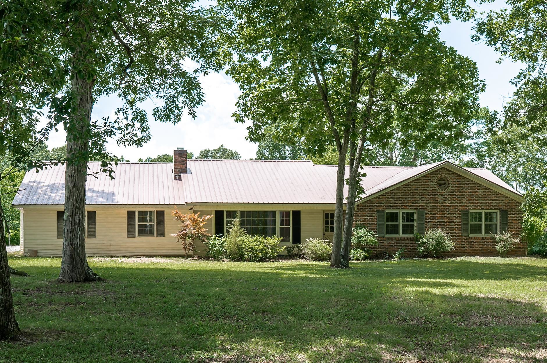 2733 New Hope Road Guys, TN 38339 - Photo 1 of 25 a front view of a house with a garden