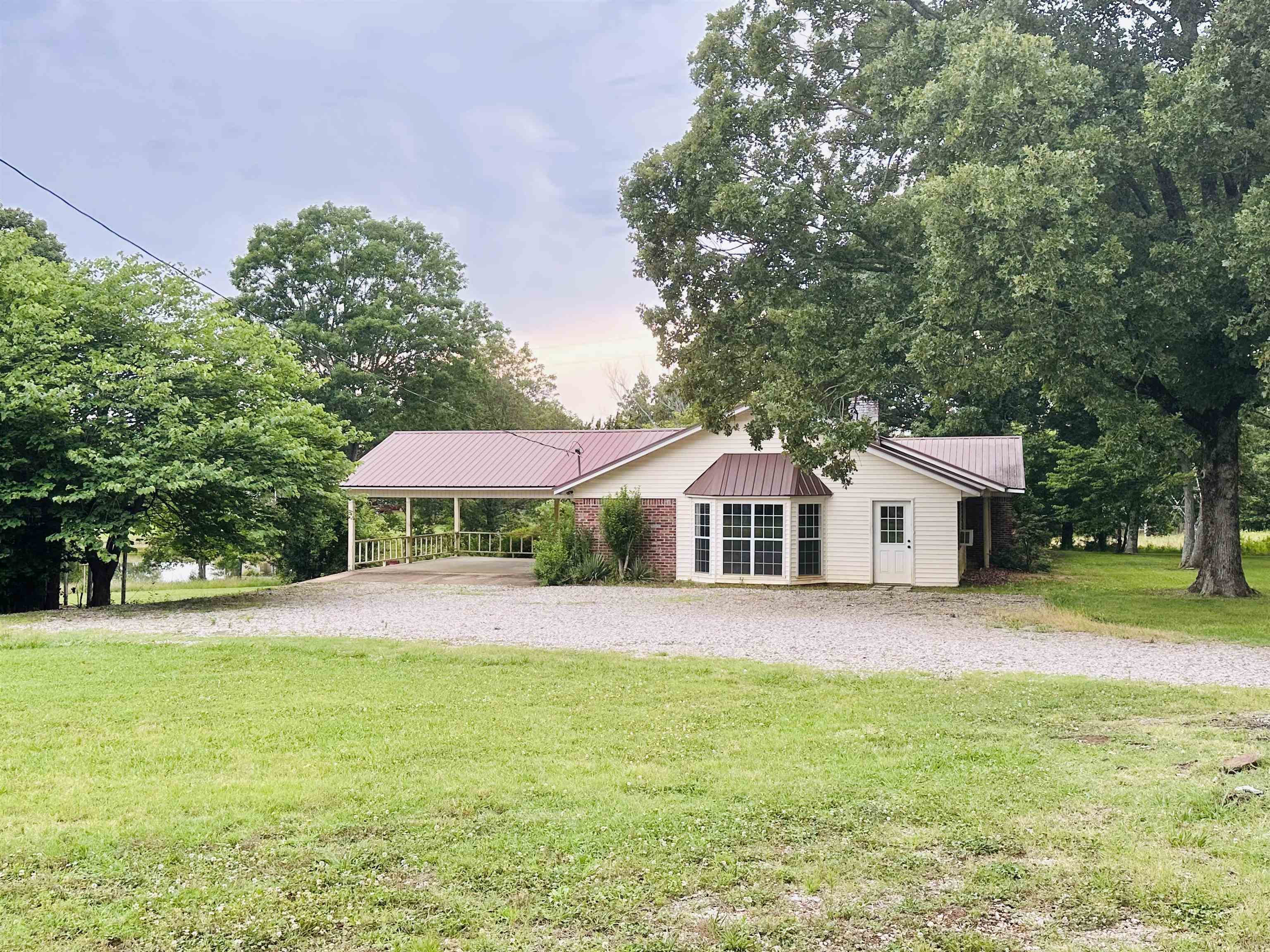 2733 New Hope Road Guys, TN 38339 - Photo 18 of 25 a front view of a house with a garden and trees