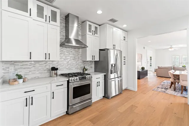 a bathroom with a granite countertop sink a mirror and shower