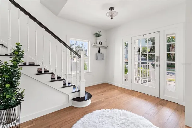 a living room with furniture a large window and a fireplace