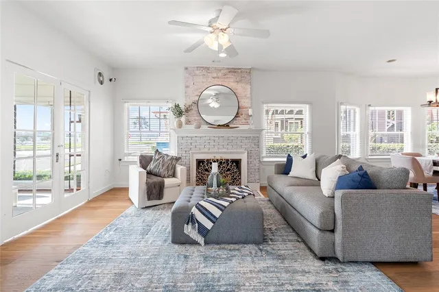 a living room with furniture a fireplace and wooden floor