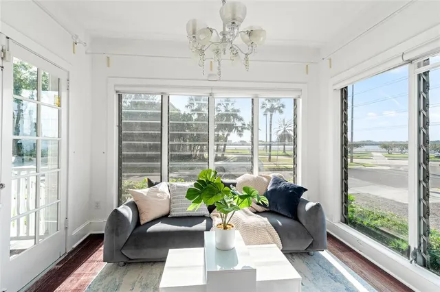 a living room with furniture a fireplace and a large window