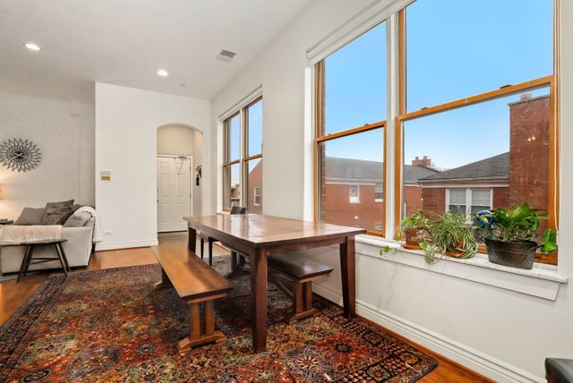 140 Ridge Avenue, Unit 2W Evanston, IL 60202 - Photo 17 of 36 a room with a table chairs and wooden floor