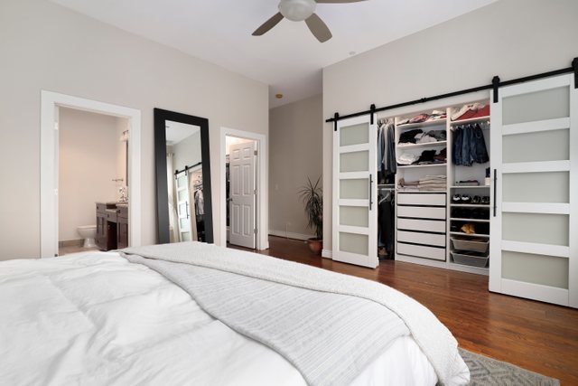 140 Ridge Avenue, Unit 2W Evanston, IL 60202 - Photo 20 of 36 a bedroom with a bed and a walk in closet