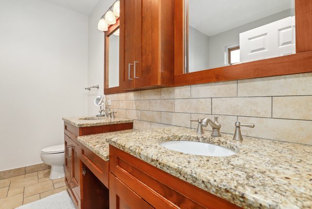 140 Ridge Avenue, Unit 2W Evanston, IL 60202 - Photo 21 of 36 a bathroom with a granite countertop sink and a toilet