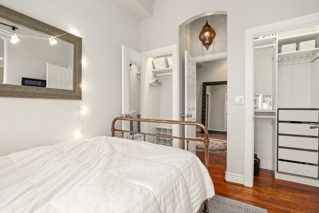 140 Ridge Avenue, Unit 2W Evanston, IL 60202 - Photo 26 of 36 a bedroom with a bed and a large mirror