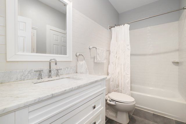 140 Ridge Avenue, Unit 2W Evanston, IL 60202 - Photo 27 of 36 a bathroom with a granite countertop sink toilet and shower