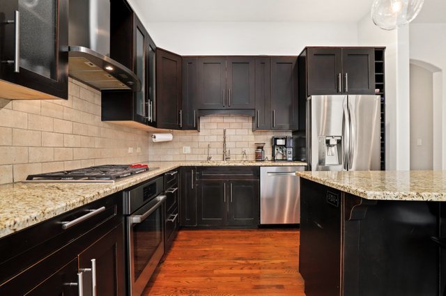 140 Ridge Avenue, Unit 2W Evanston, IL 60202 - Photo 4 of 36 a kitchen with stainless steel appliances granite countertop a sink stove and refrigerator