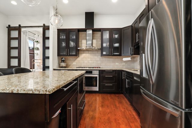 140 Ridge Avenue, Unit 2W Evanston, IL 60202 - Photo 5 of 36 a kitchen with stainless steel appliances granite countertop a sink stove and refrigerator