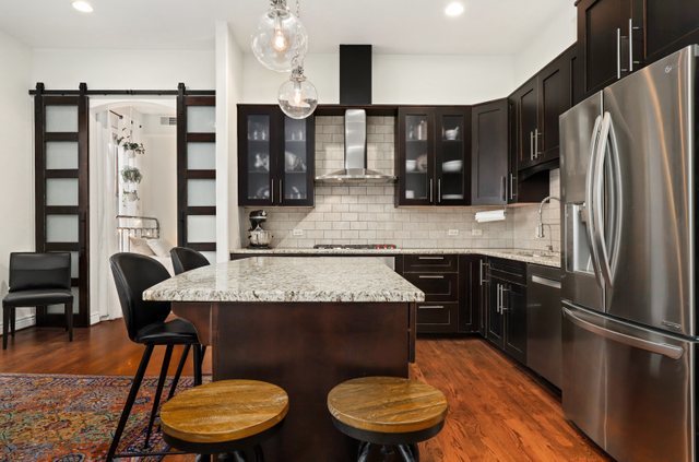 140 Ridge Avenue, Unit 2W Evanston, IL 60202 - Photo 9 of 36 a kitchen with stainless steel appliances granite countertop a sink refrigerator and cabinets