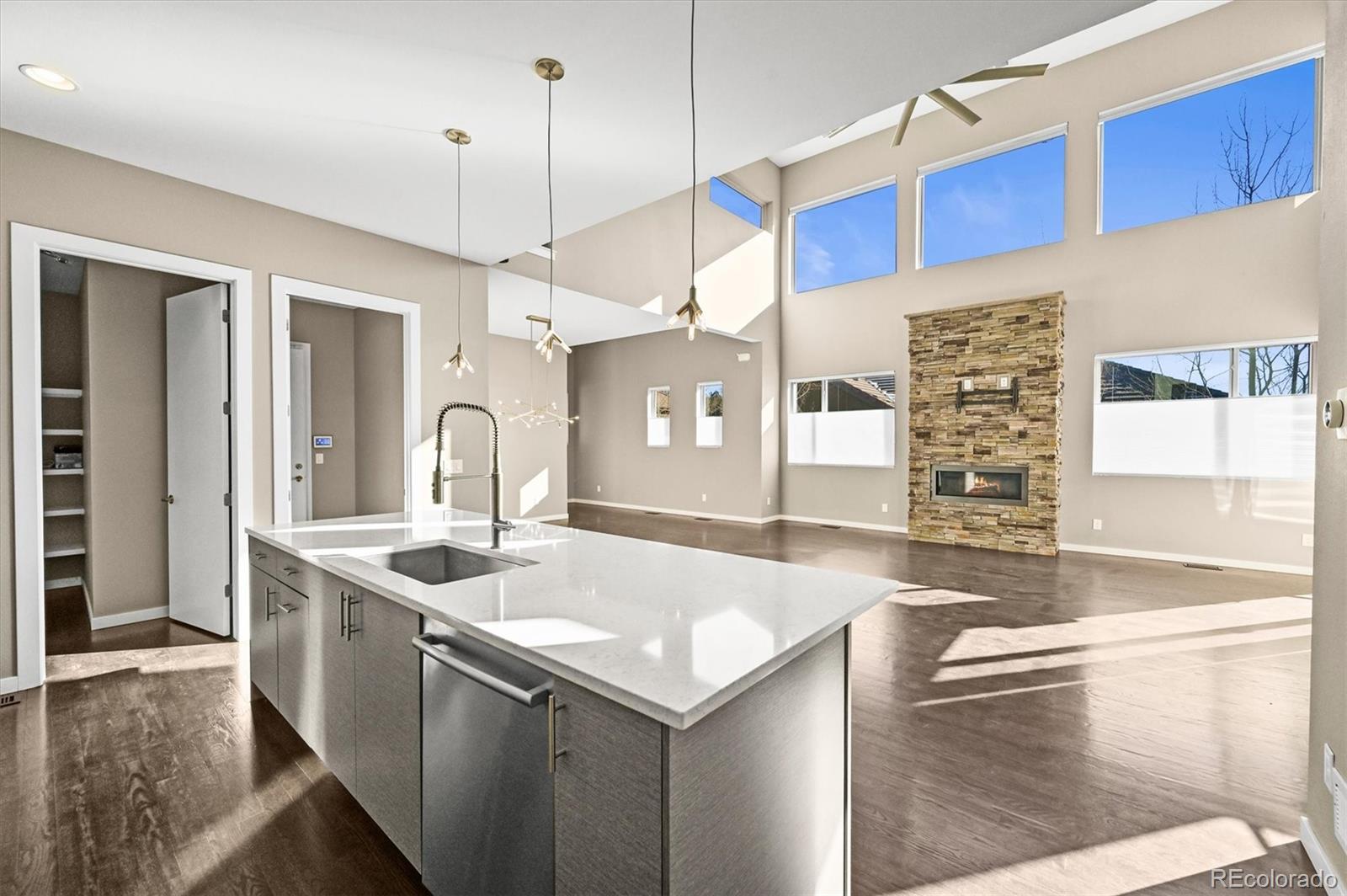 28424 Tepees Way Evergreen, CO 80439 - Photo 11 of 47 a kitchen with stainless steel appliances granite countertop a sink and a refrigerator