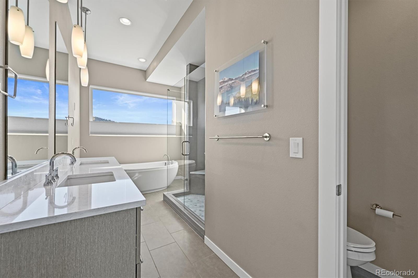 28424 Tepees Way Evergreen, CO 80439 - Photo 18 of 47 a bathroom with a sink and a mirror