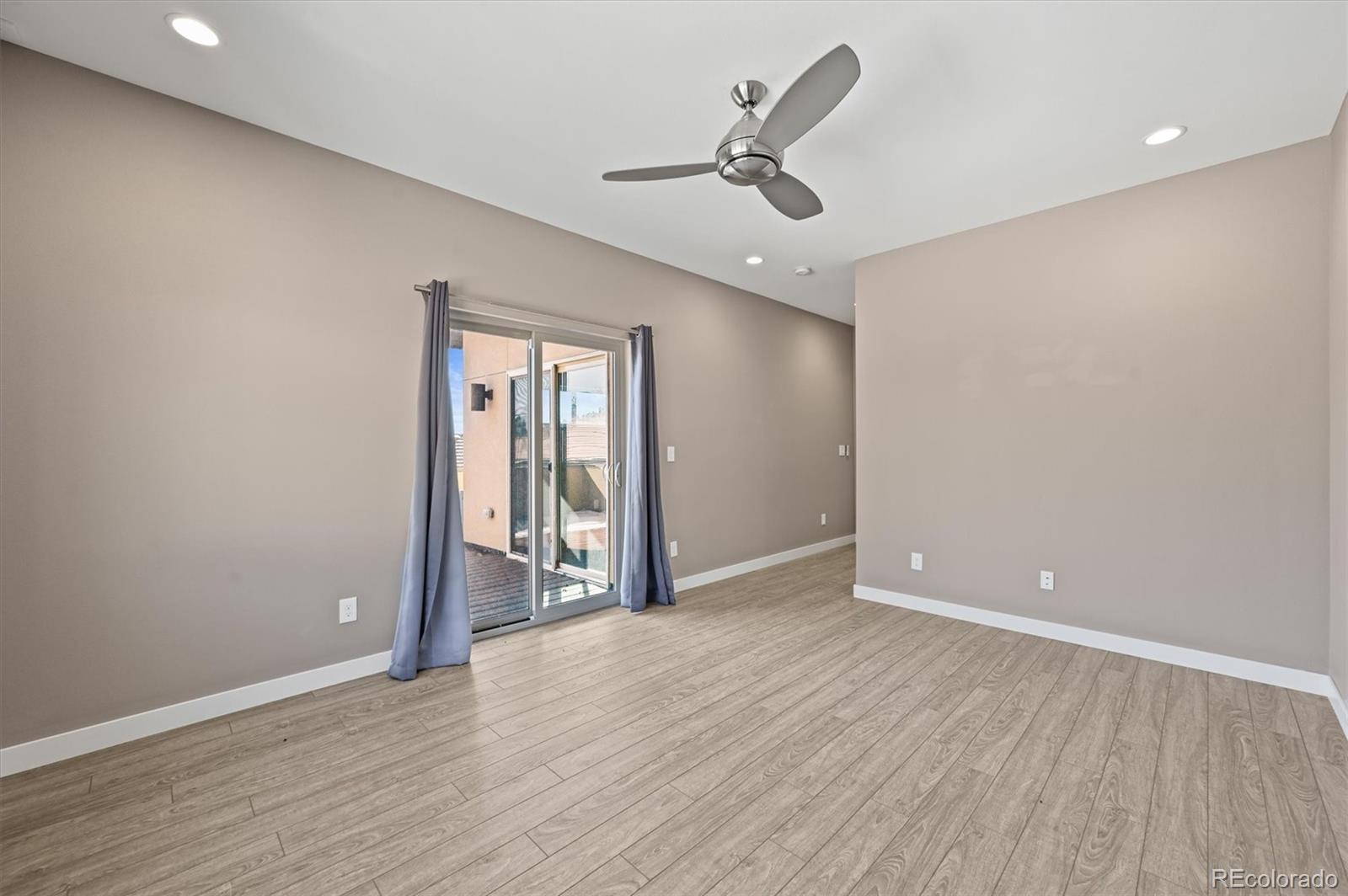 28424 Tepees Way Evergreen, CO 80439 - Photo 26 of 47 a view of empty room with wooden floor and fan