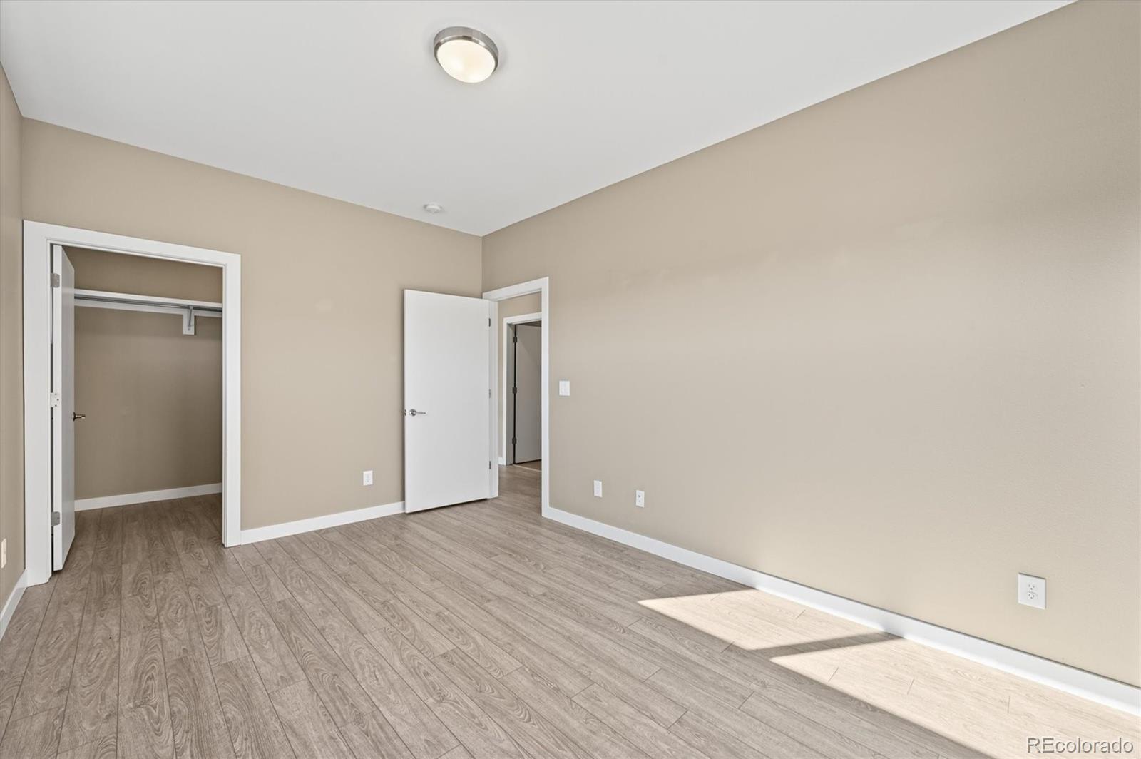 28424 Tepees Way Evergreen, CO 80439 - Photo 28 of 47 an empty room with wooden floor and closet