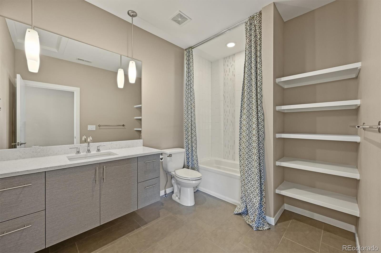 28424 Tepees Way Evergreen, CO 80439 - Photo 29 of 47 a bathroom with a double vanity sink and a toilet