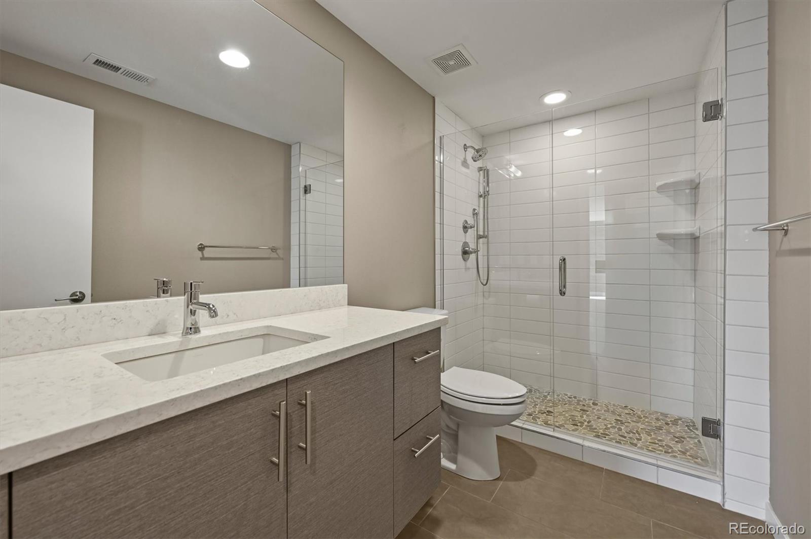 28424 Tepees Way Evergreen, CO 80439 - Photo 35 of 47 a bathroom with a sink a toilet and shower