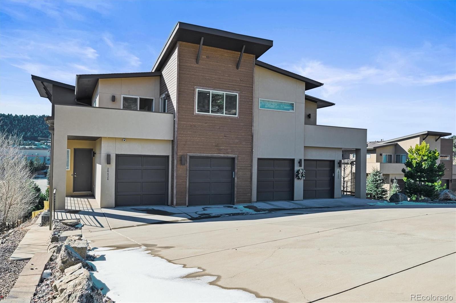 28424 Tepees Way Evergreen, CO 80439 - Photo 39 of 47 a front view of a house with a yard