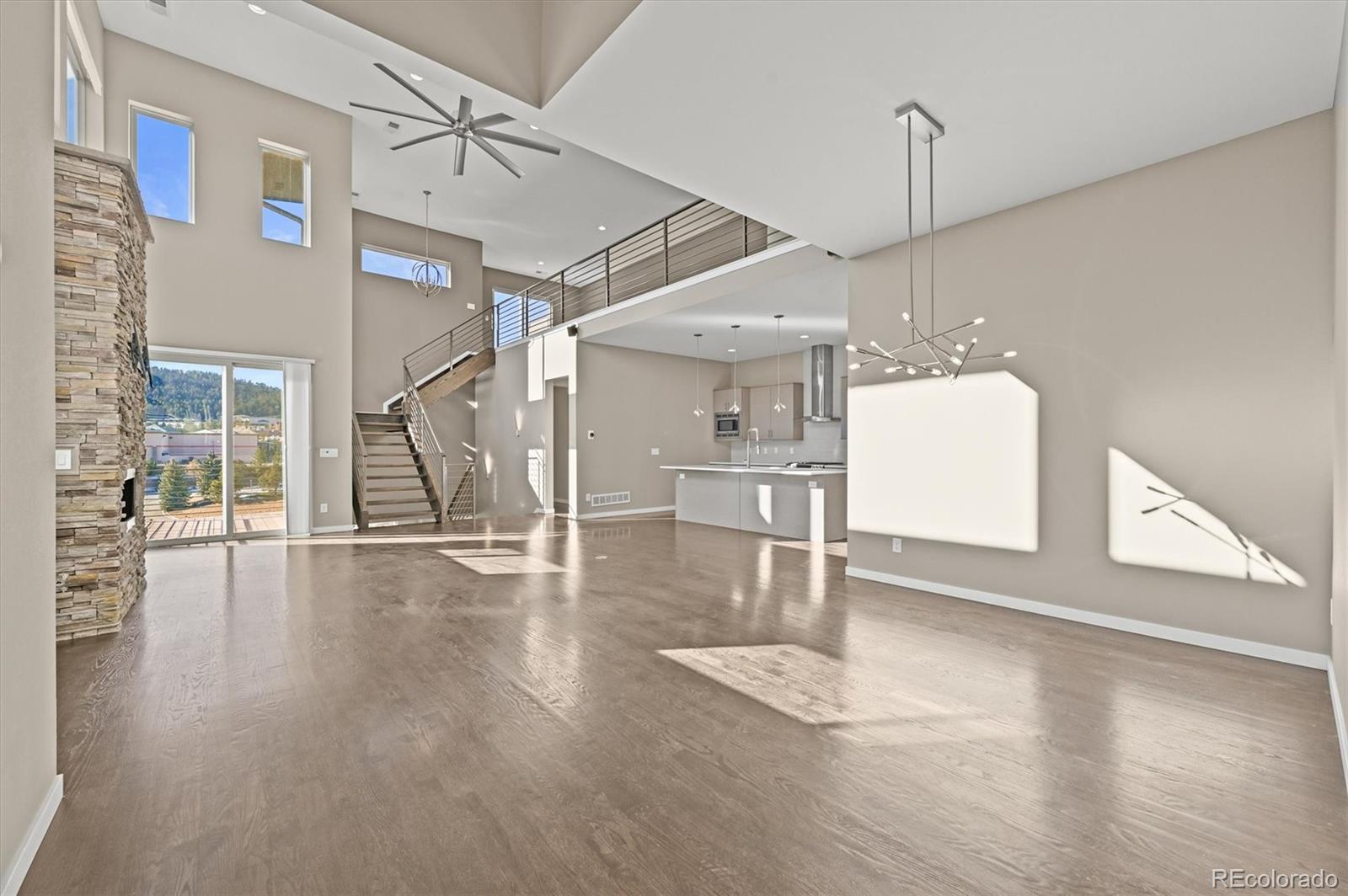 28424 Tepees Way Evergreen, CO 80439 - Photo 4 of 47 a view of a room with wooden floor