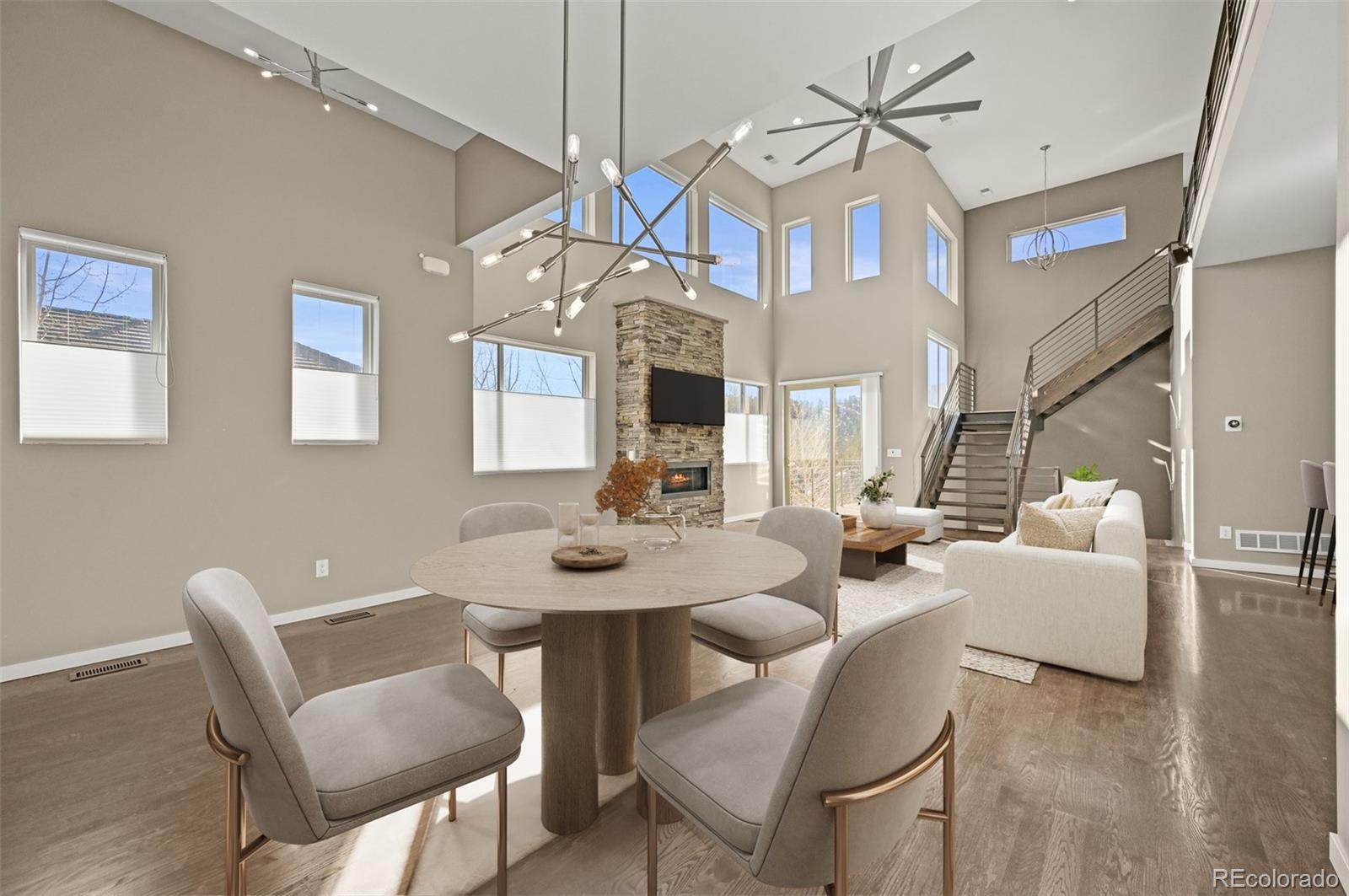 28424 Tepees Way Evergreen, CO 80439 - Photo 5 of 47 a view of a dining room with furniture wooden floor and chandelier