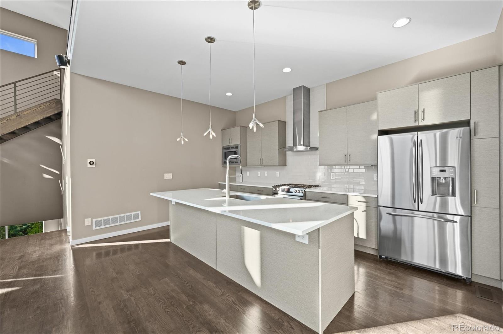 28424 Tepees Way Evergreen, CO 80439 - Photo 9 of 47 a kitchen with a sink stainless steel appliances and cabinets